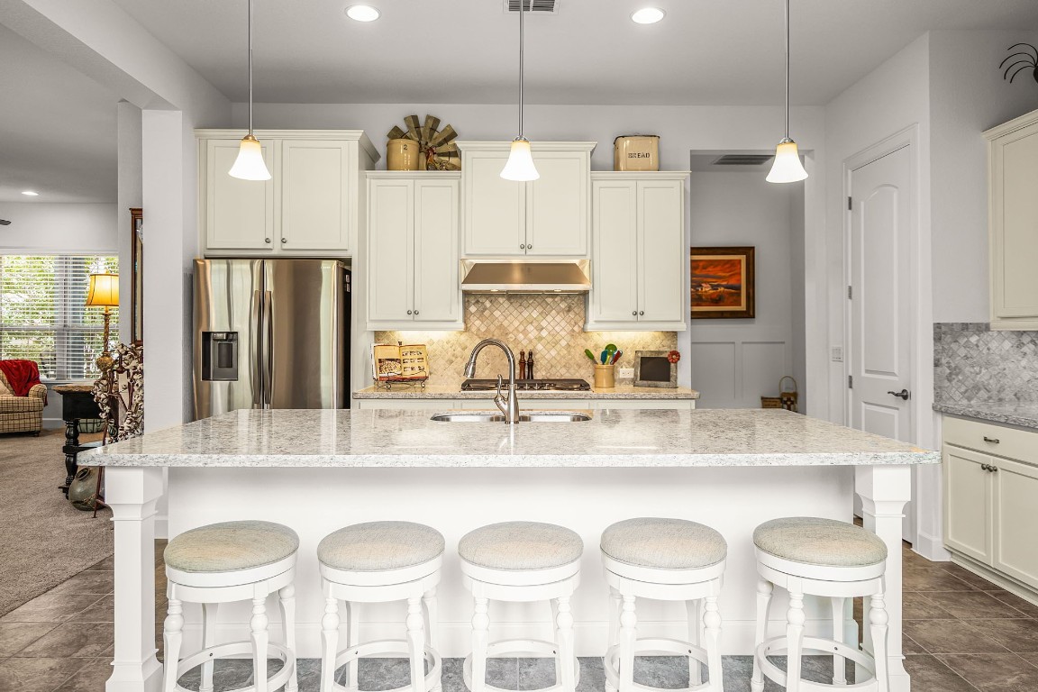 a kitchen with a dining table cabinets and appliances