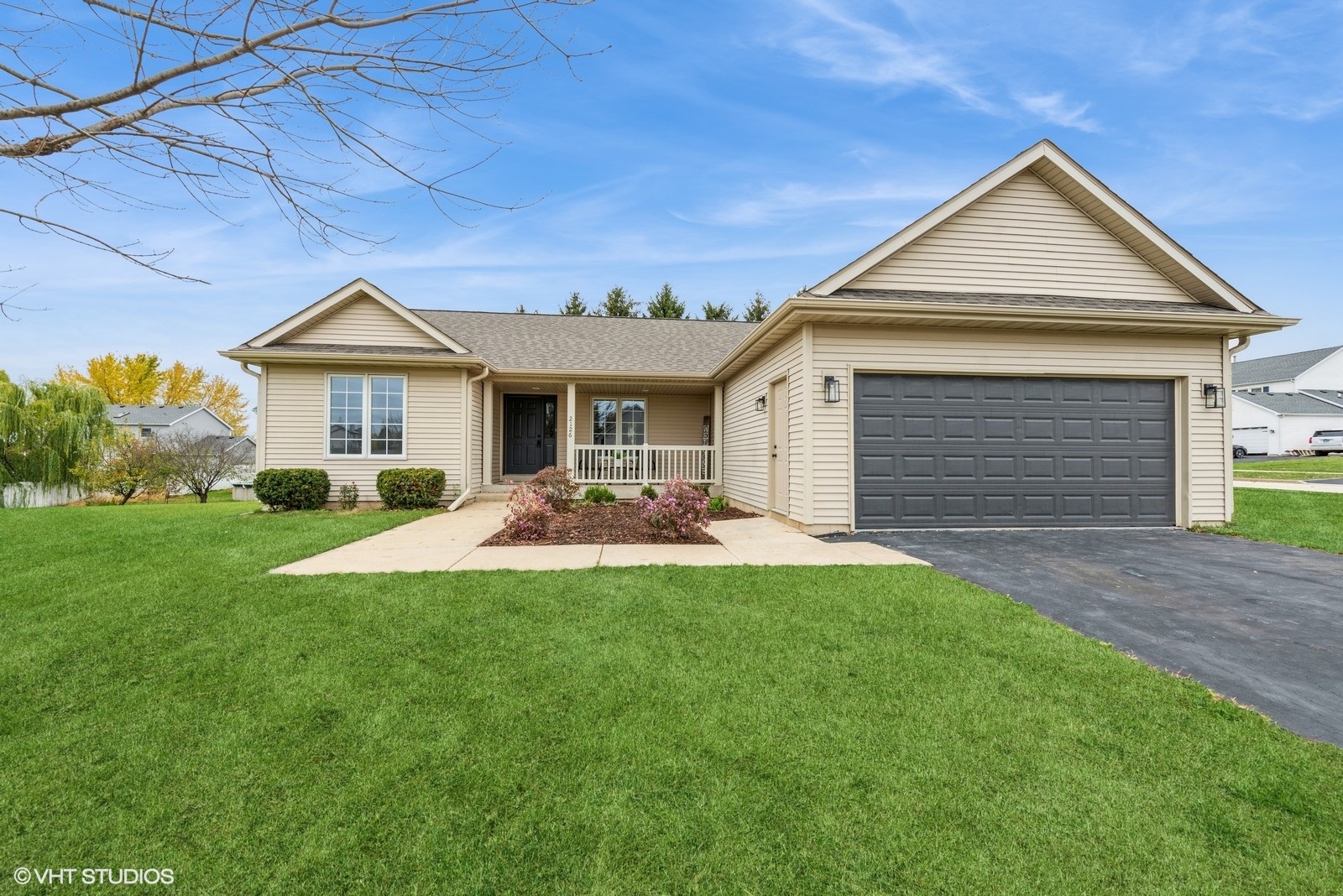 a front view of a house with a yard and garage