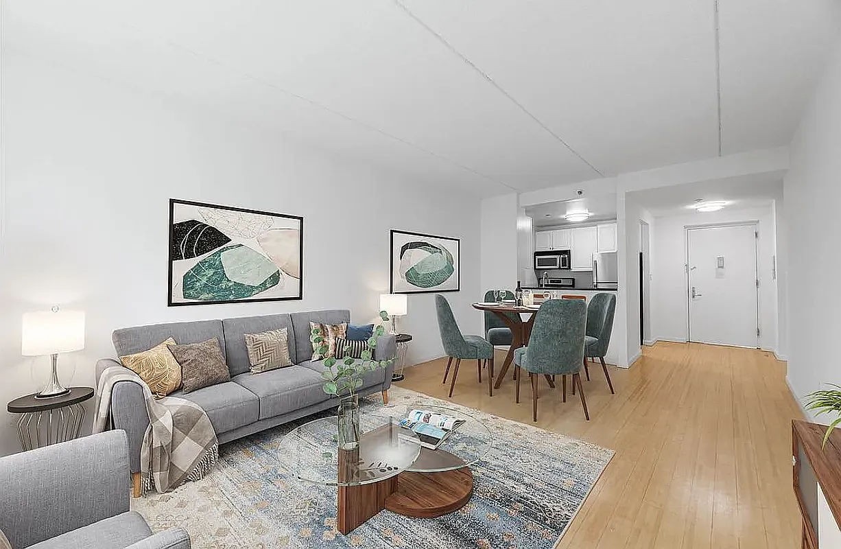 a living room with furniture and a dining table with kitchen view