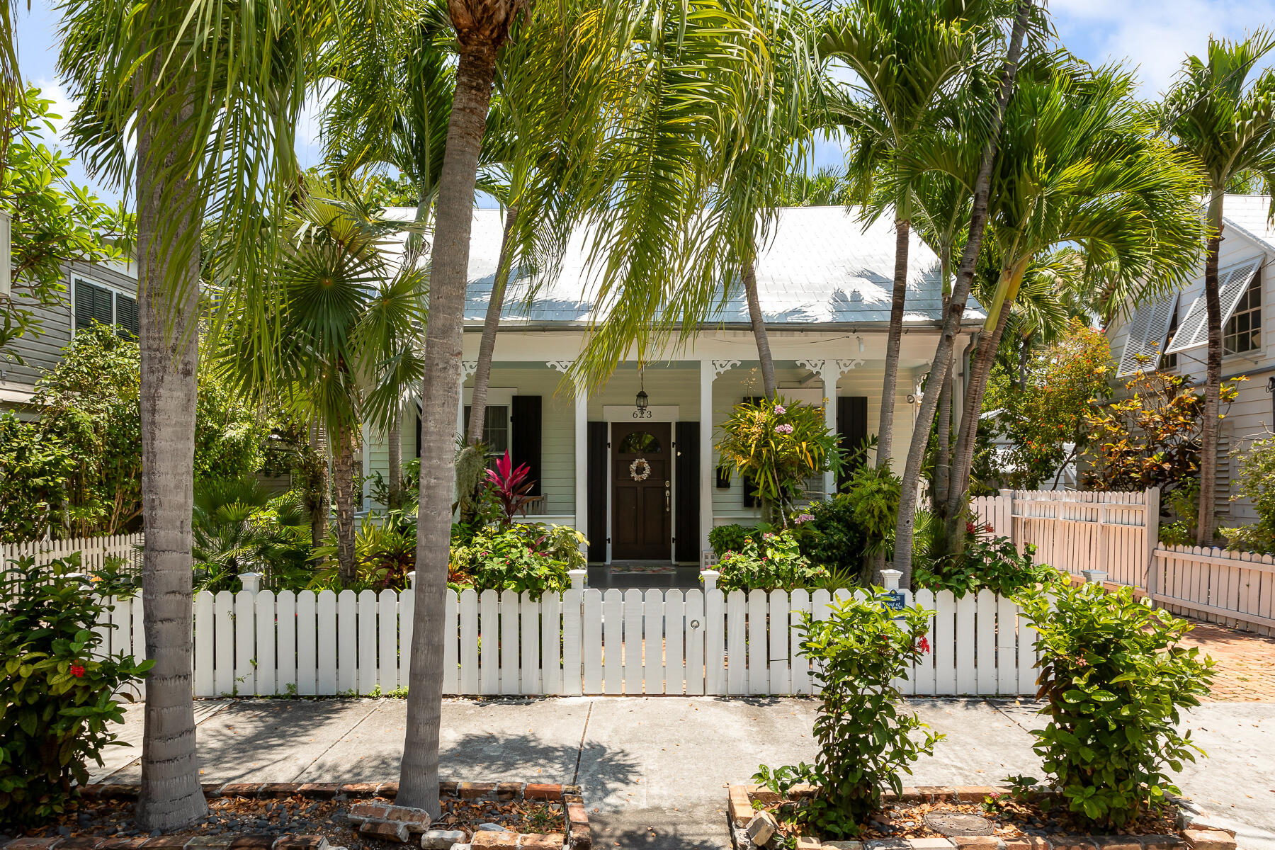 a front view of a house with a garden