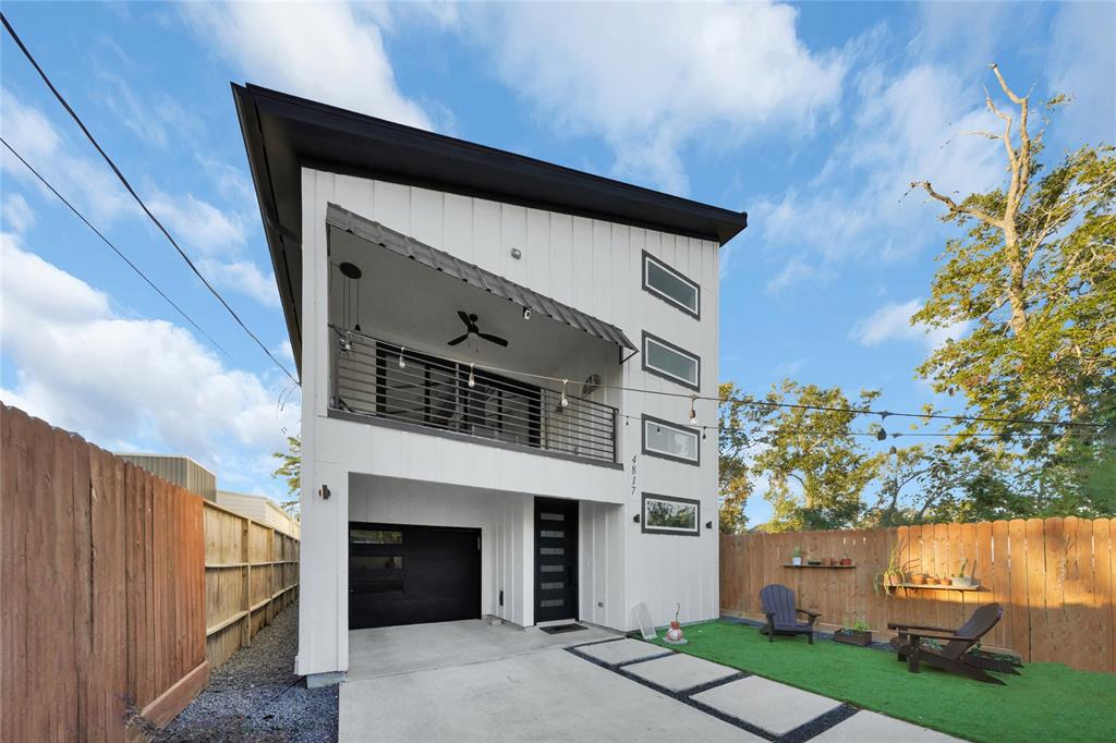 Front of the home with 3 car garage and front yard