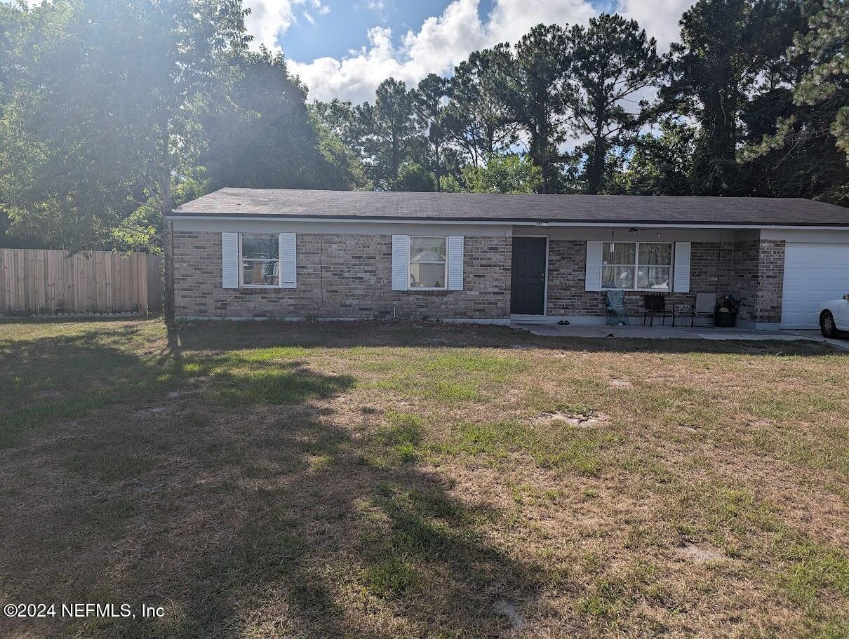 a front view of house with yard and trees