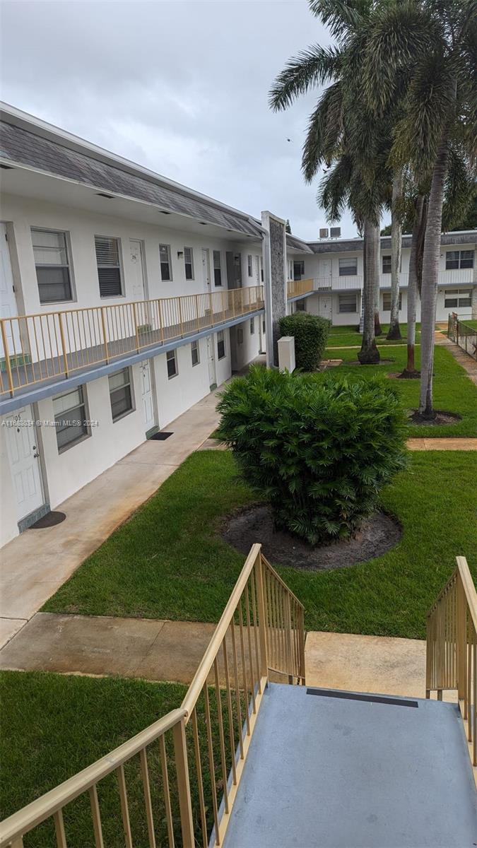 a view of house with backyard and garden