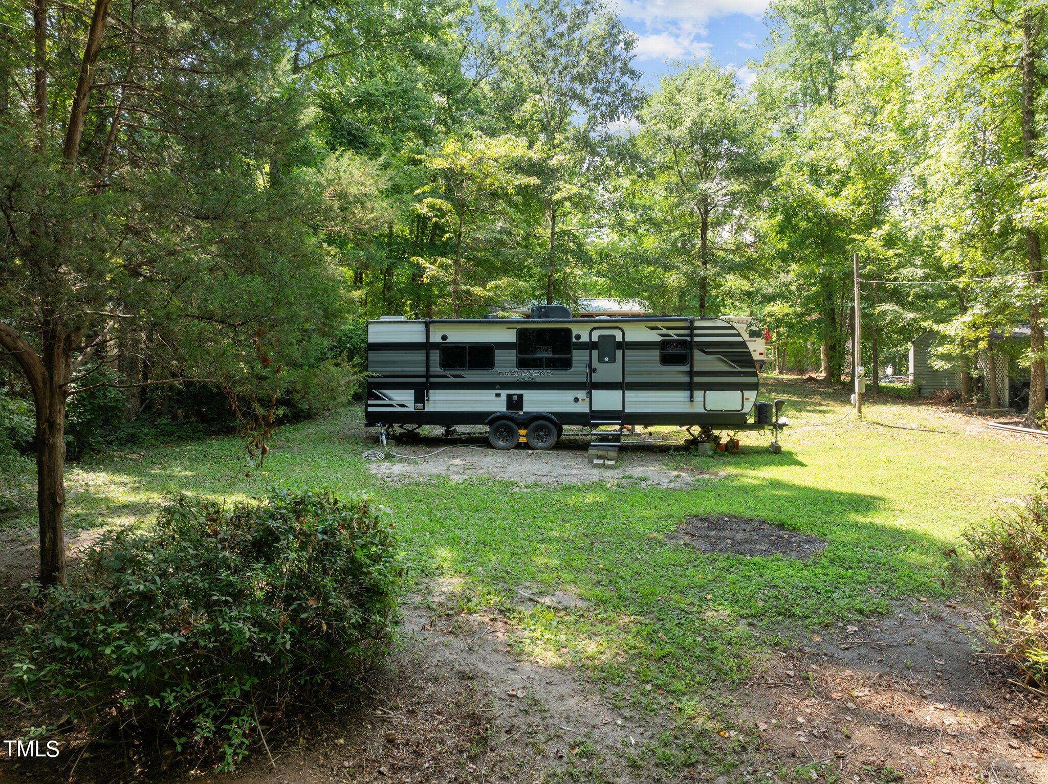 a backyard of a house with barbeque oven table and chairs