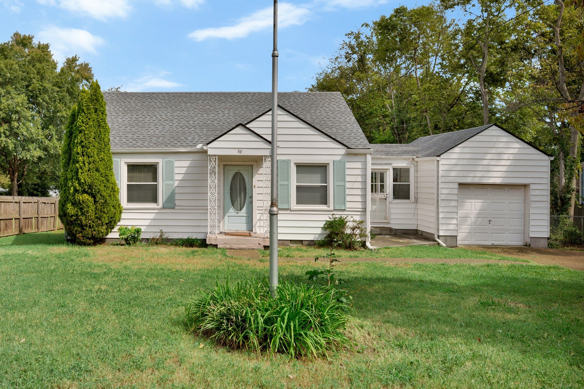 a front view of a house with a garden