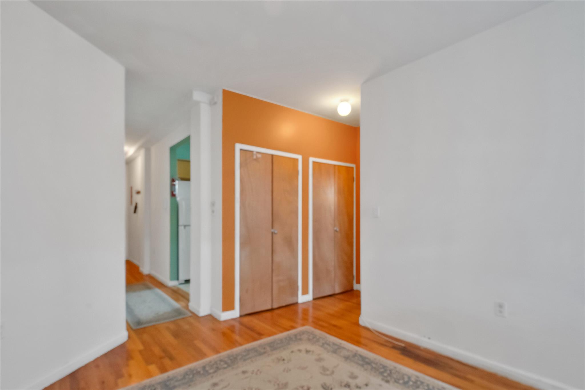 Empty room with hardwood / wood-style flooring