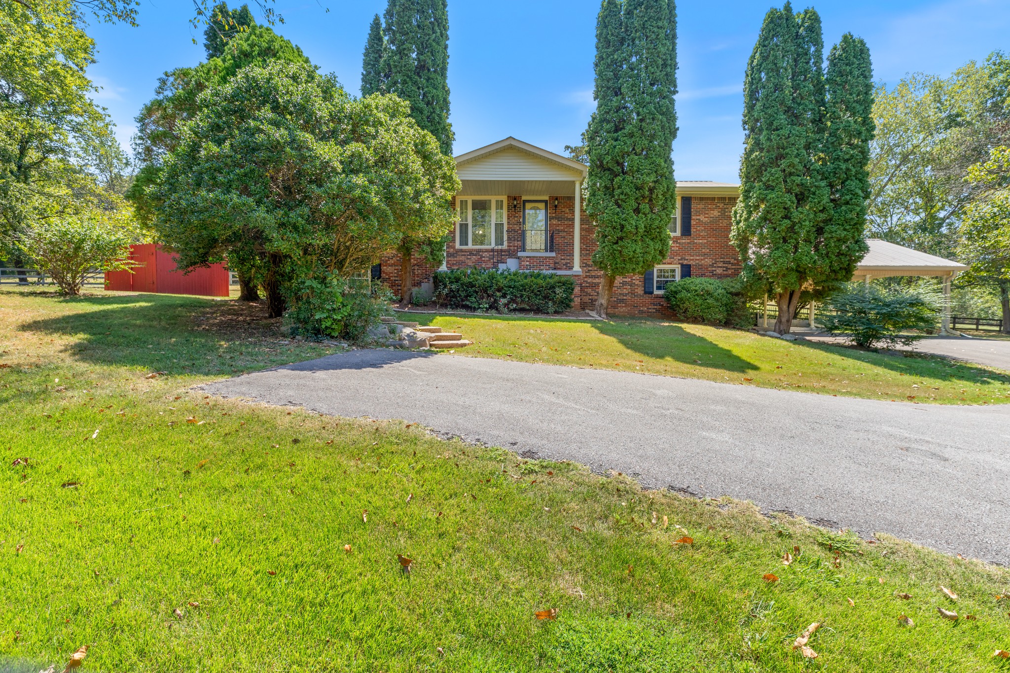 a view of house with outdoor space and garden