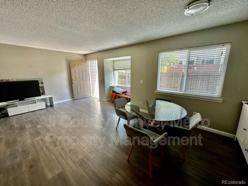 a living room with furniture a window and a flat screen tv