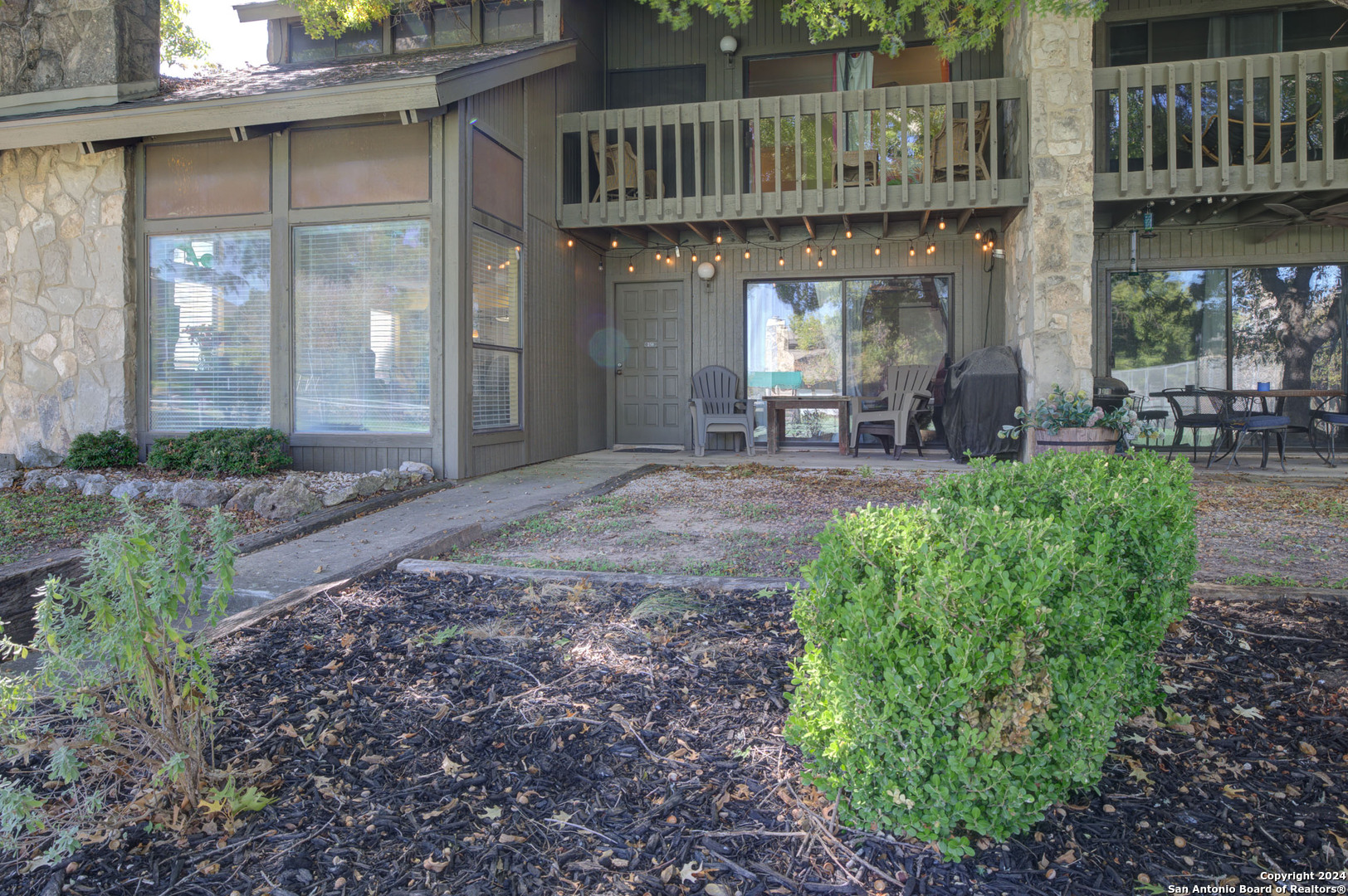 a view of a house with sitting area and garden