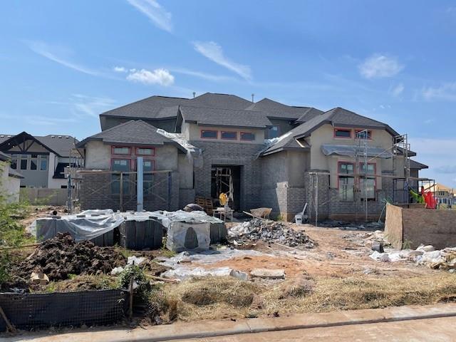 a front view of a house with cars parked