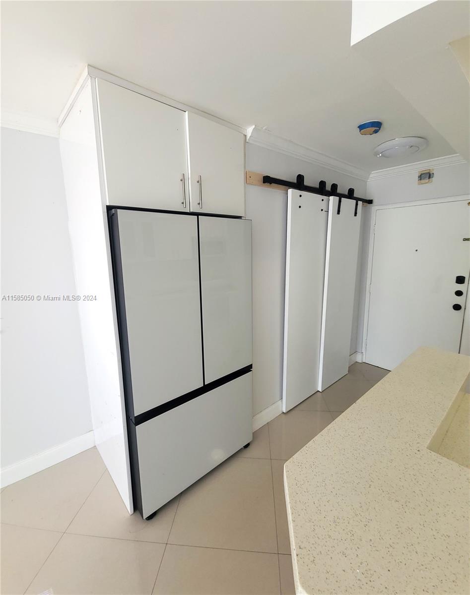 a view of a storage & utility room with a sink