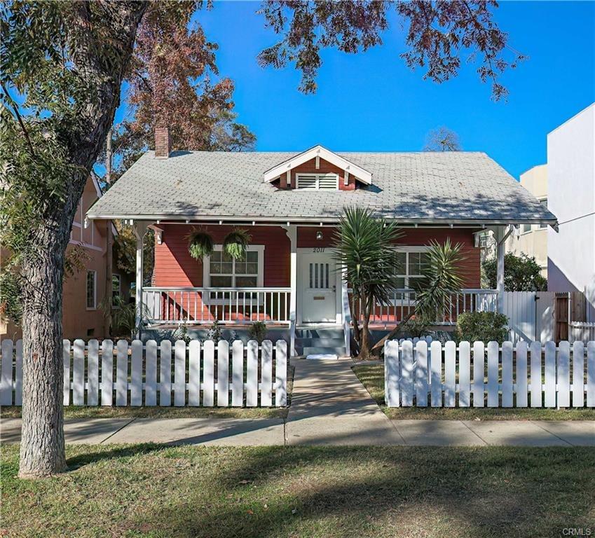 a view of a house with a small yard and a garden