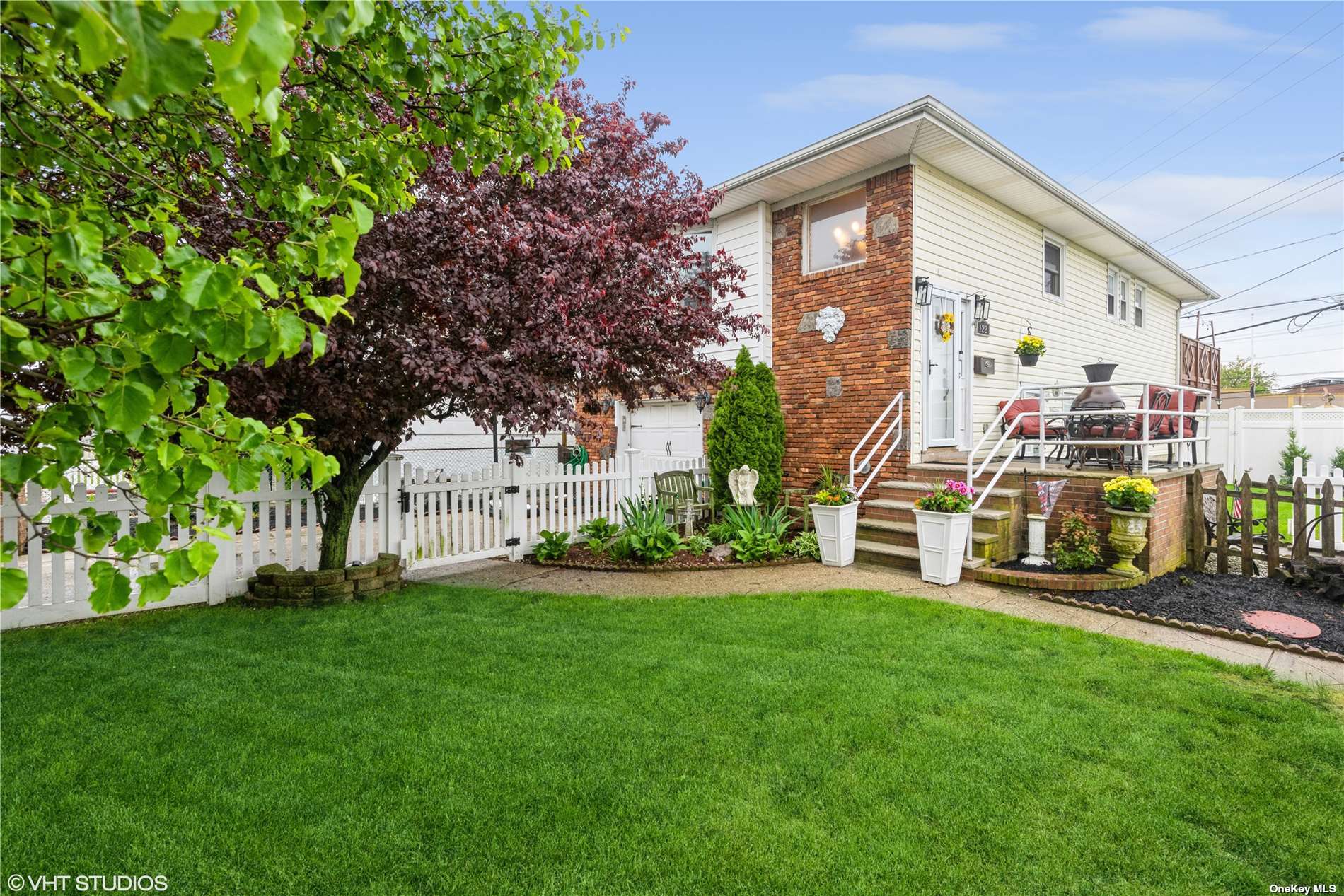 a view of a house with a yard and sitting area