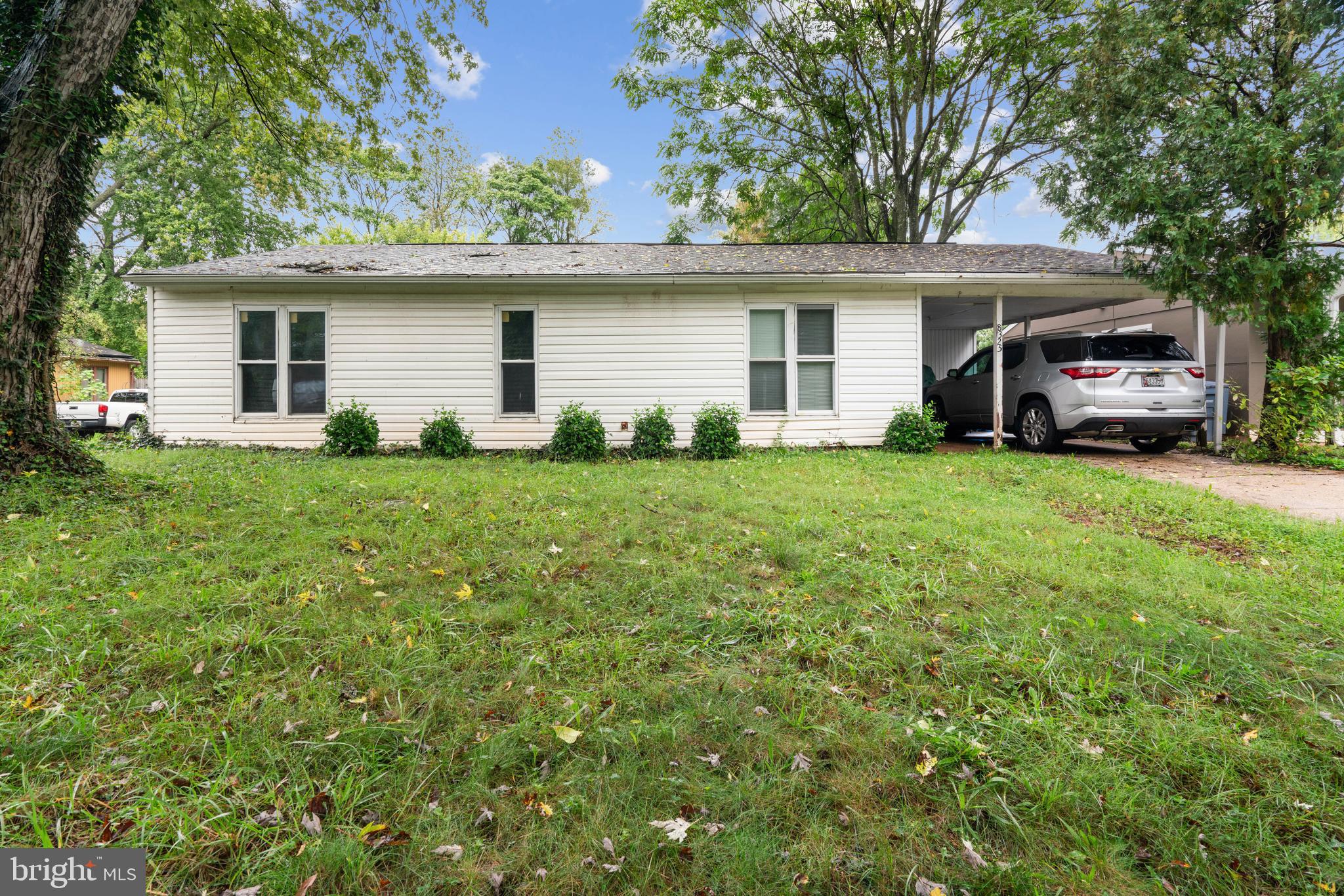 a view of a house with a backyard