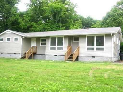 a view of a house with backyard sitting area and garden