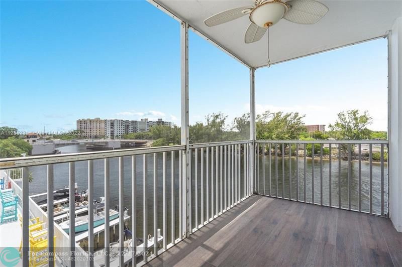 a view of a balcony with wooden floor