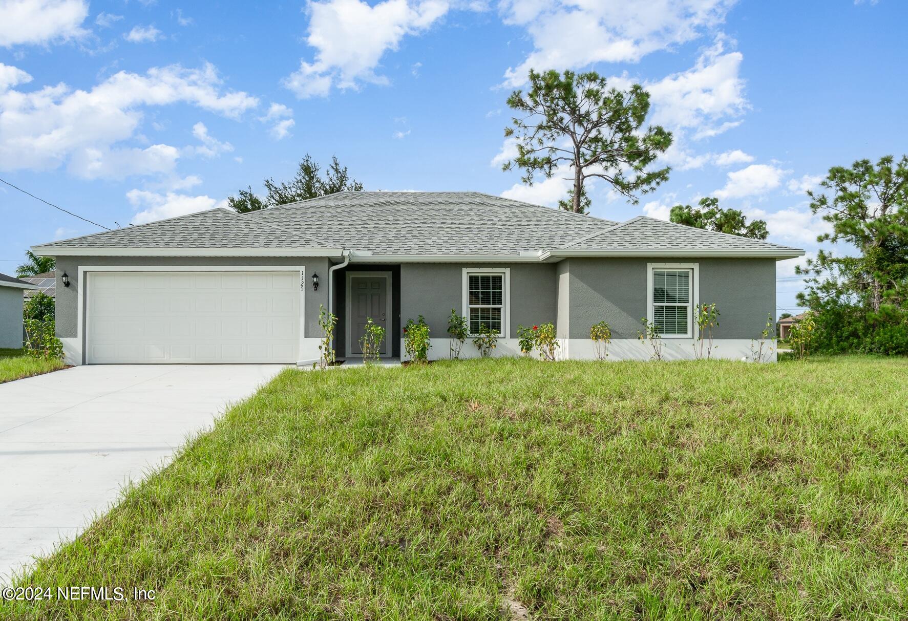 a front view of a house with a garden