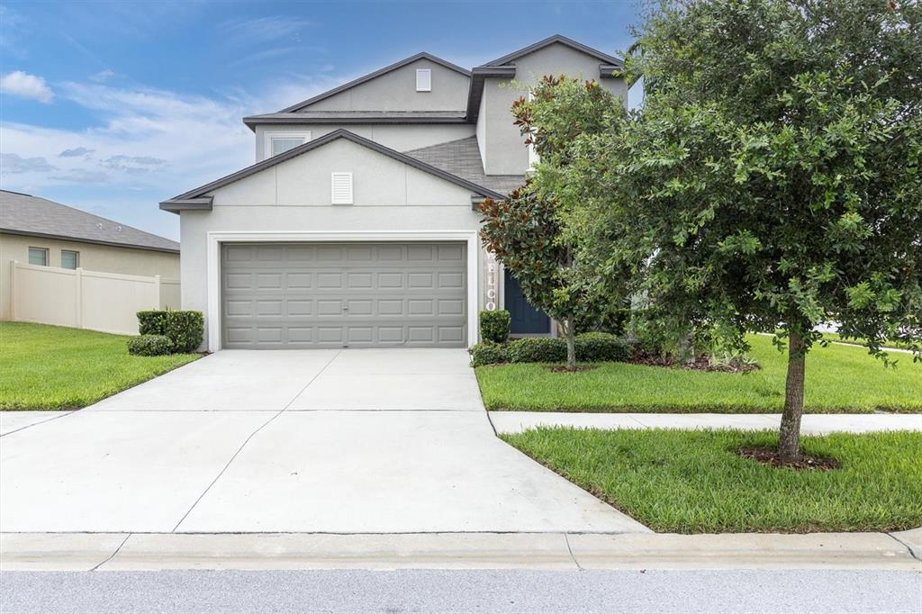 a front view of a house with a yard and garage