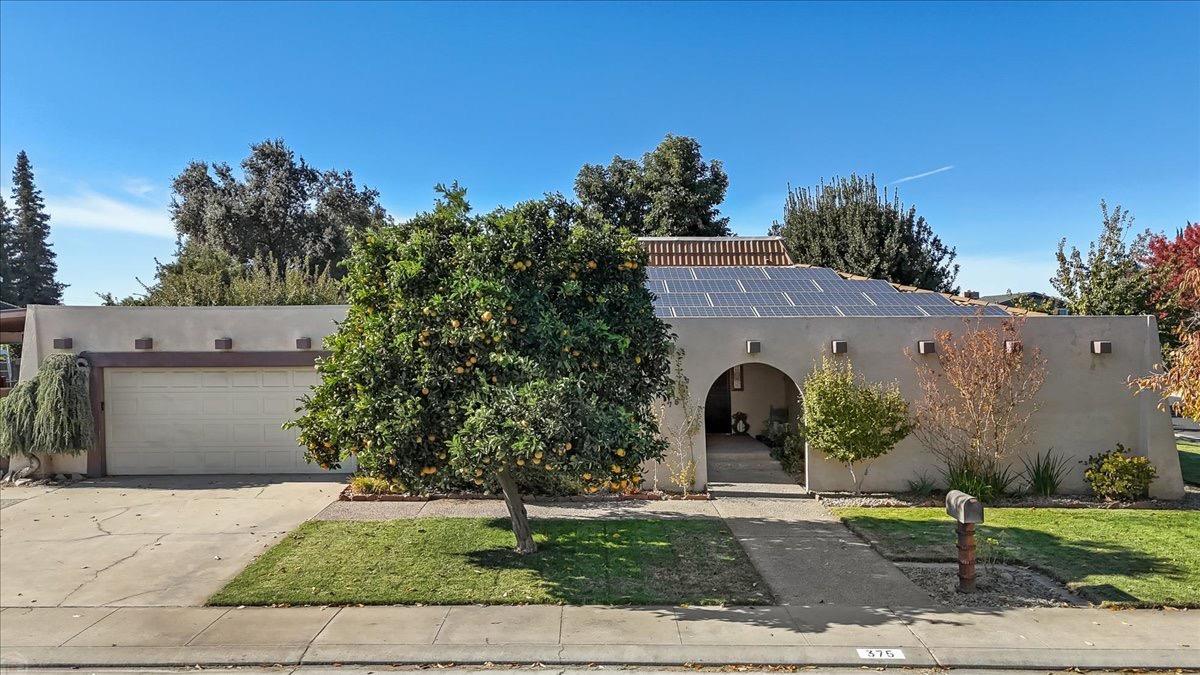 a front view of a house with garden