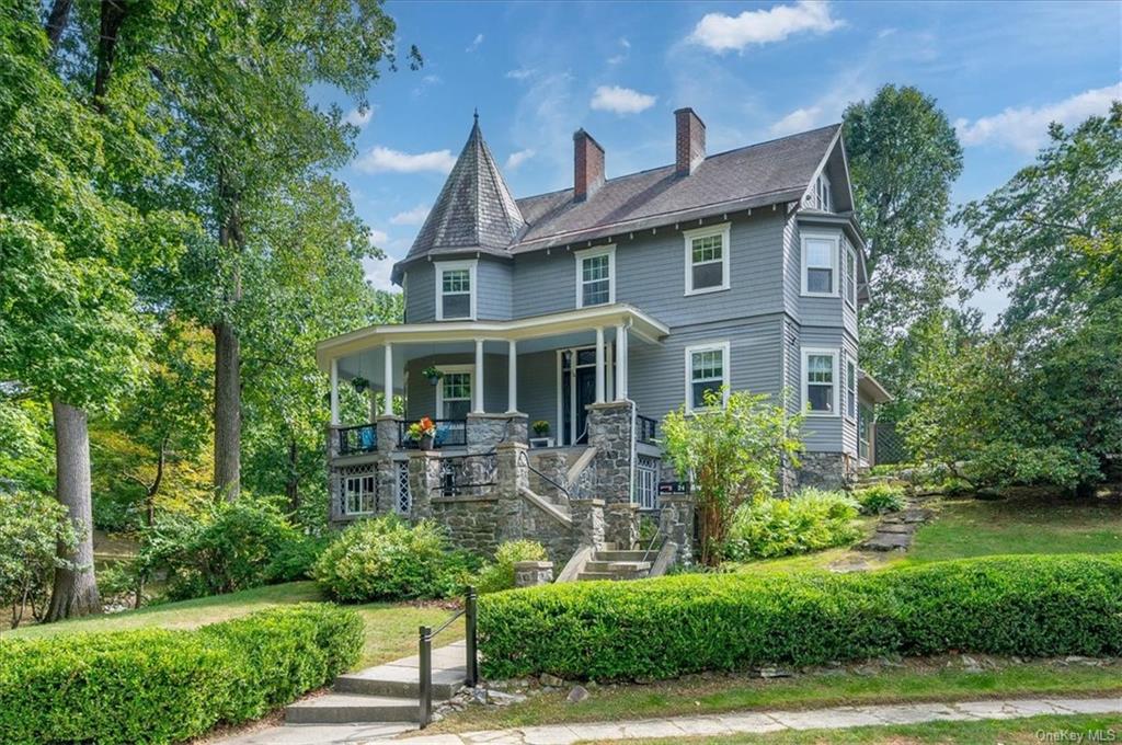 Victorian house with covered wrap around front porch.