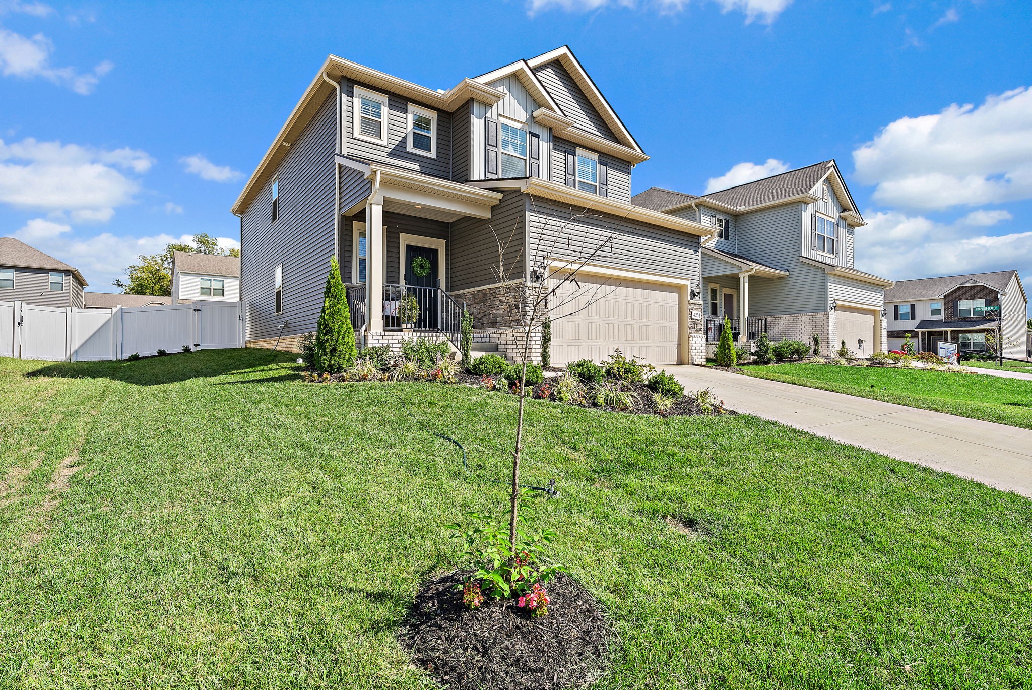 a front view of a house with a garden and plants