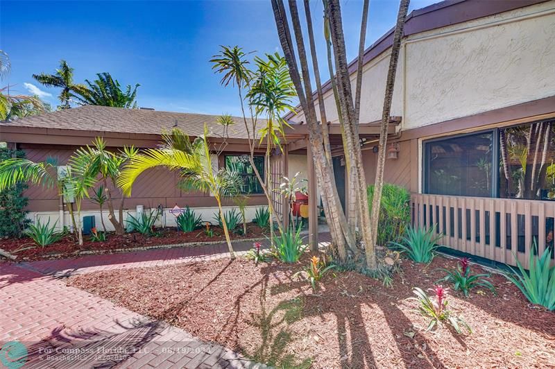 a view of an house with backyard and a patio