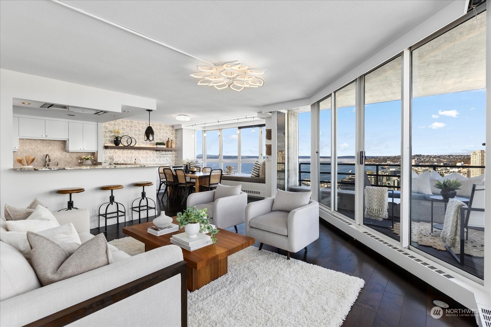 a living room with furniture and a view of kitchen