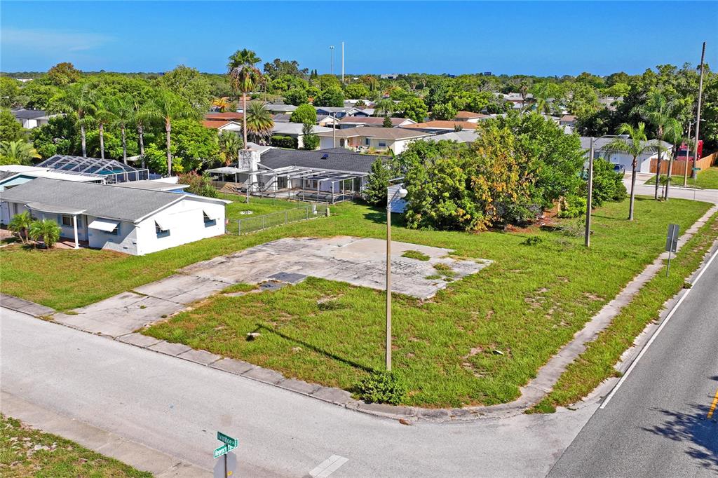 an aerial view of a house with a garden and trees