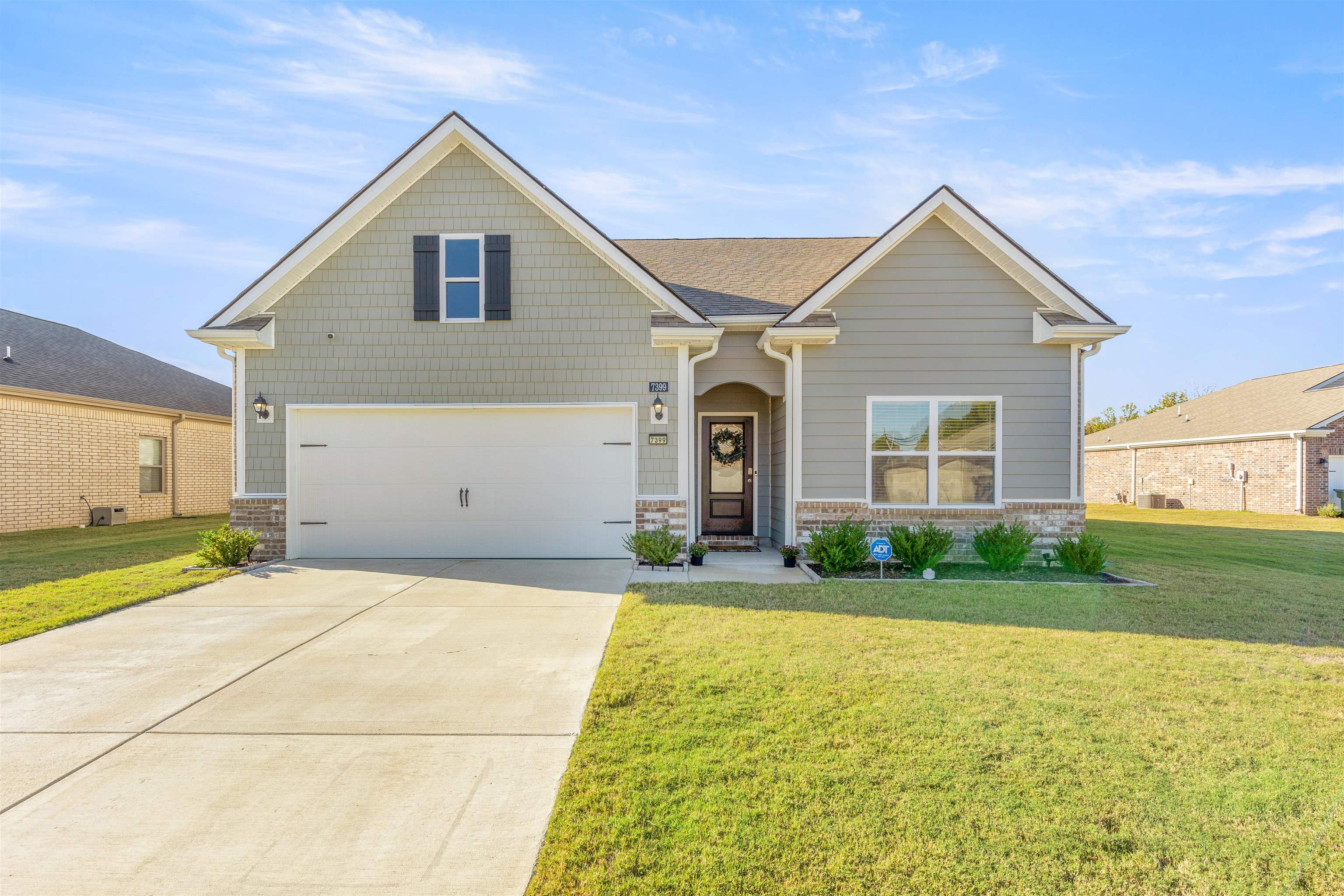 a view of a house with a yard and garage