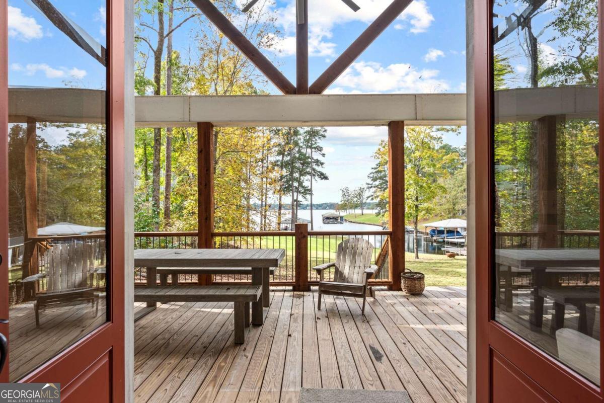 a view of a living room and floor to ceiling window with wooden floor