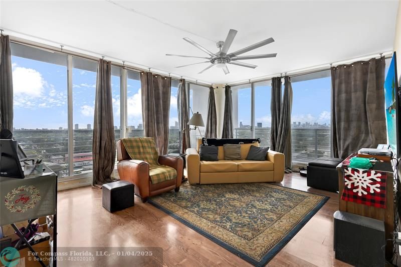 a living room with furniture and a large window