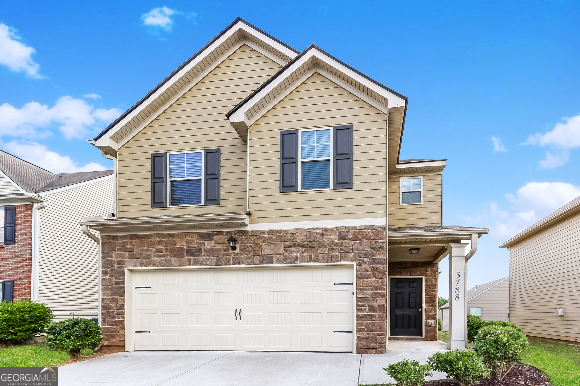 a front view of a house with a garage