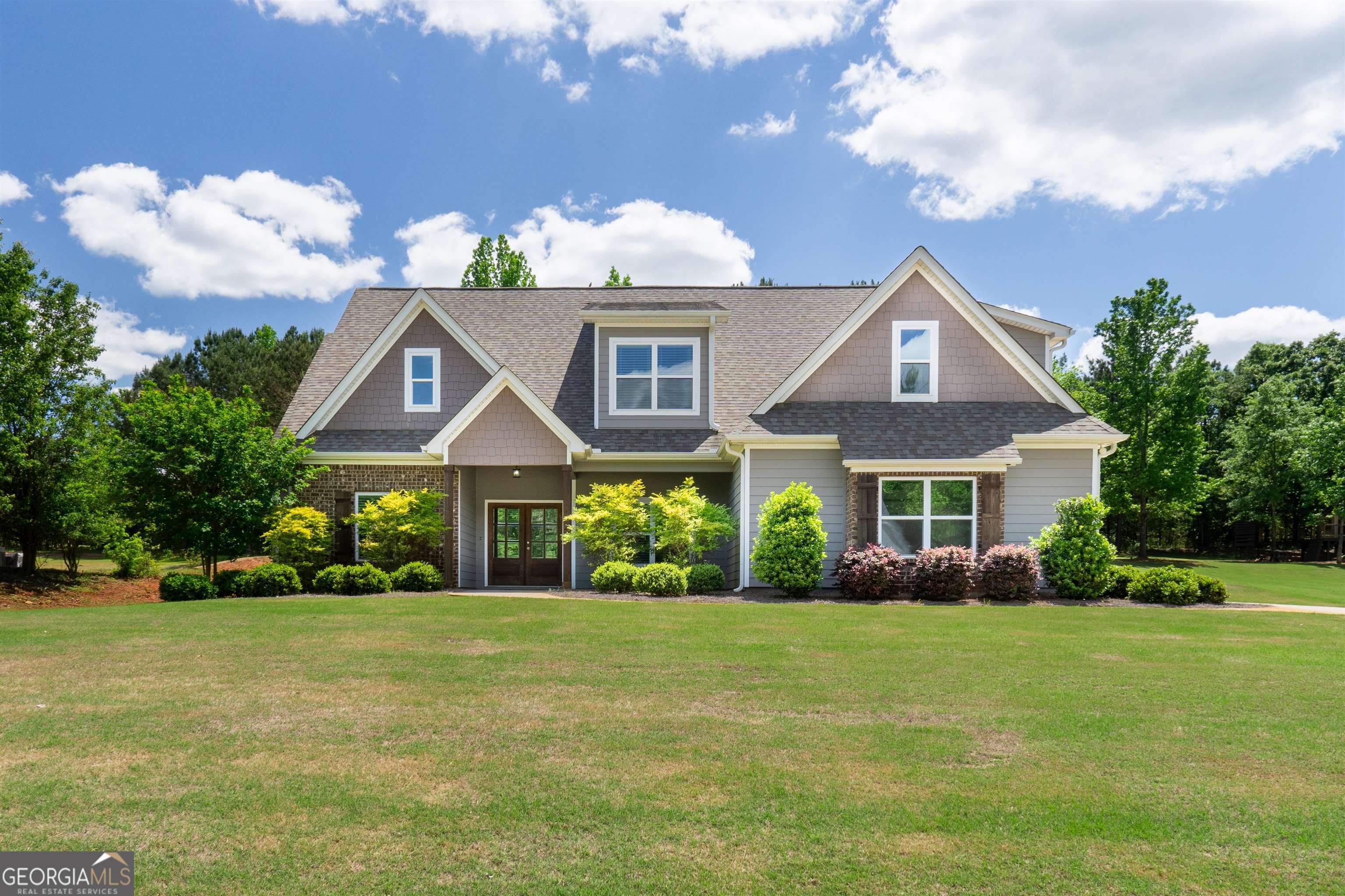 a front view of a house with garden