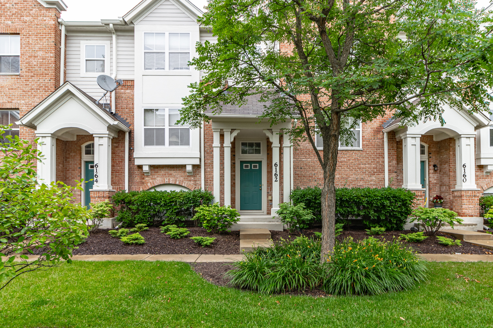 front view of a house with a yard