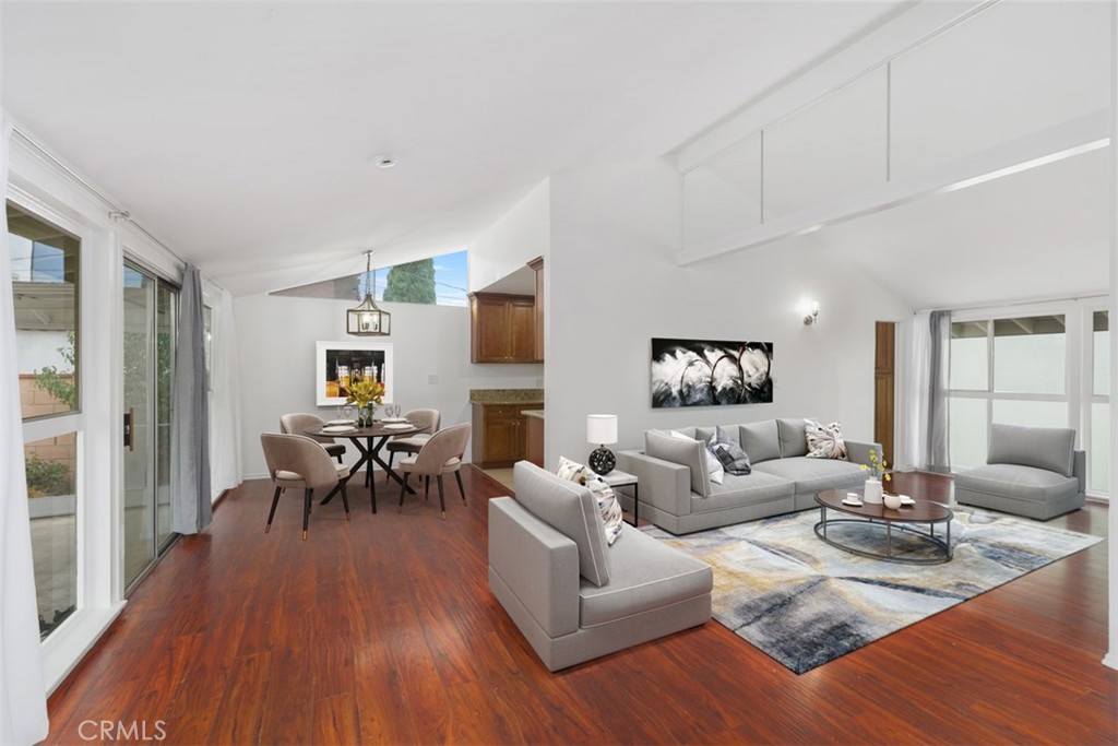 a living room with furniture wooden floor and a flat screen tv