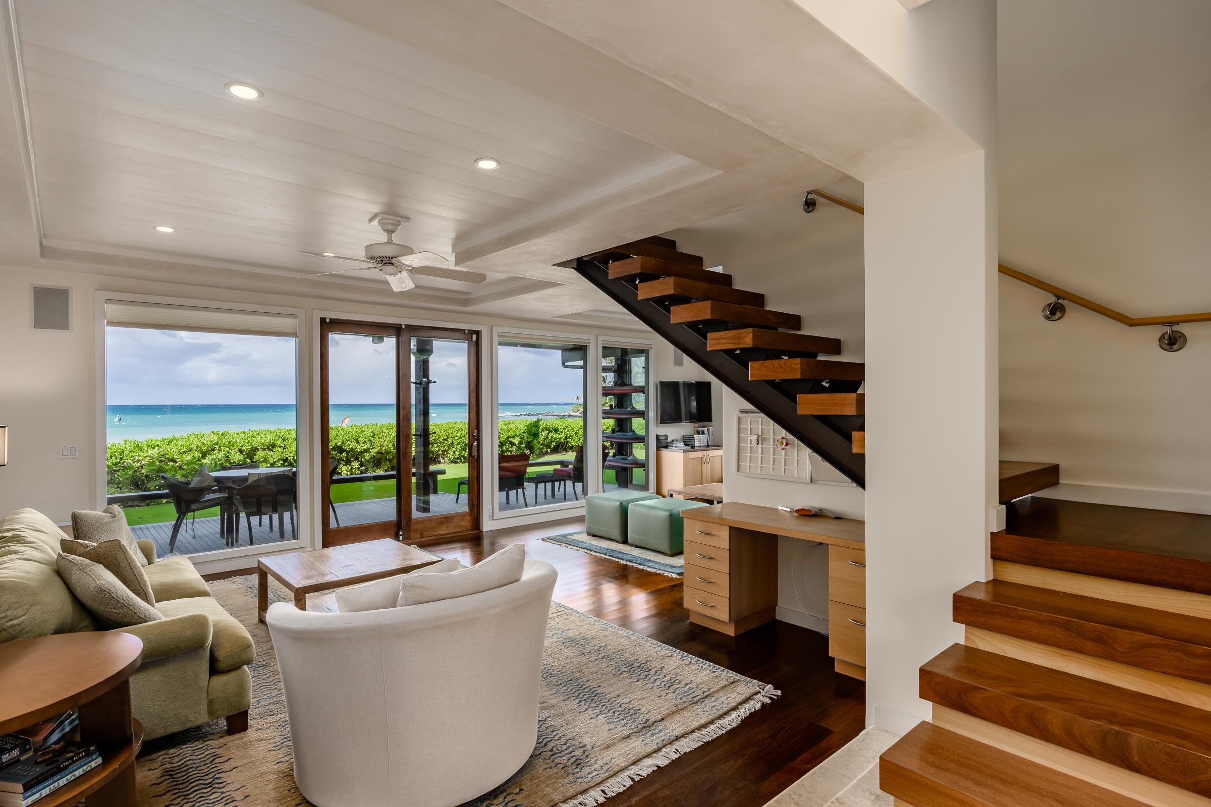 a living room with furniture and floor to ceiling windows