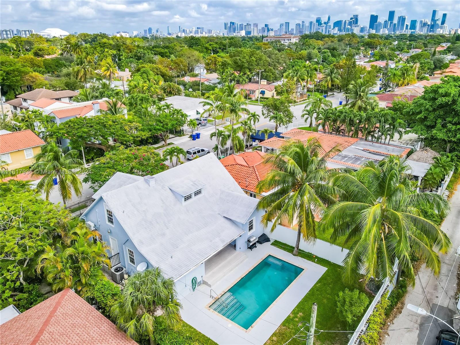 an aerial view of a house with a yard basket ball court and outdoor seating