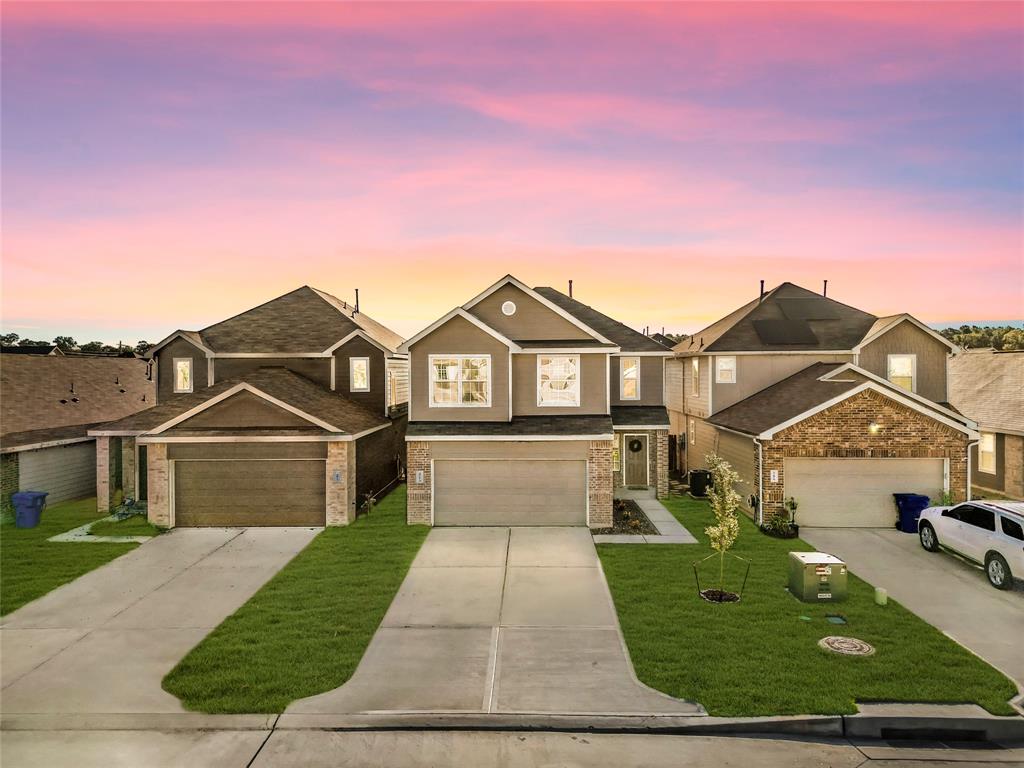 a view of a big house with a big yard and large trees