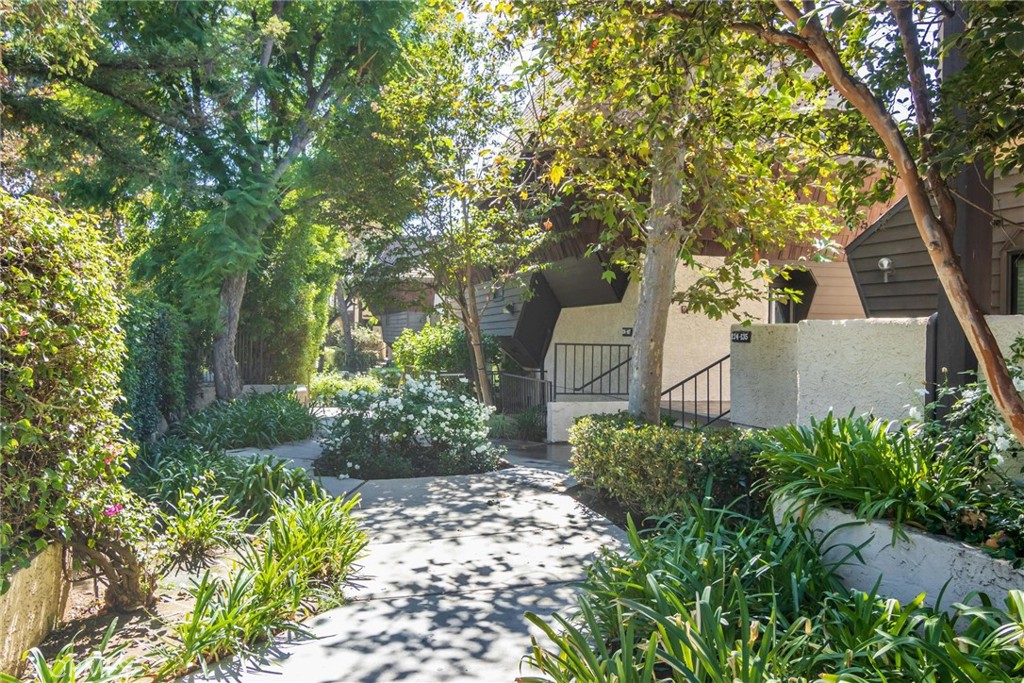 a view of a house with a yard and garden