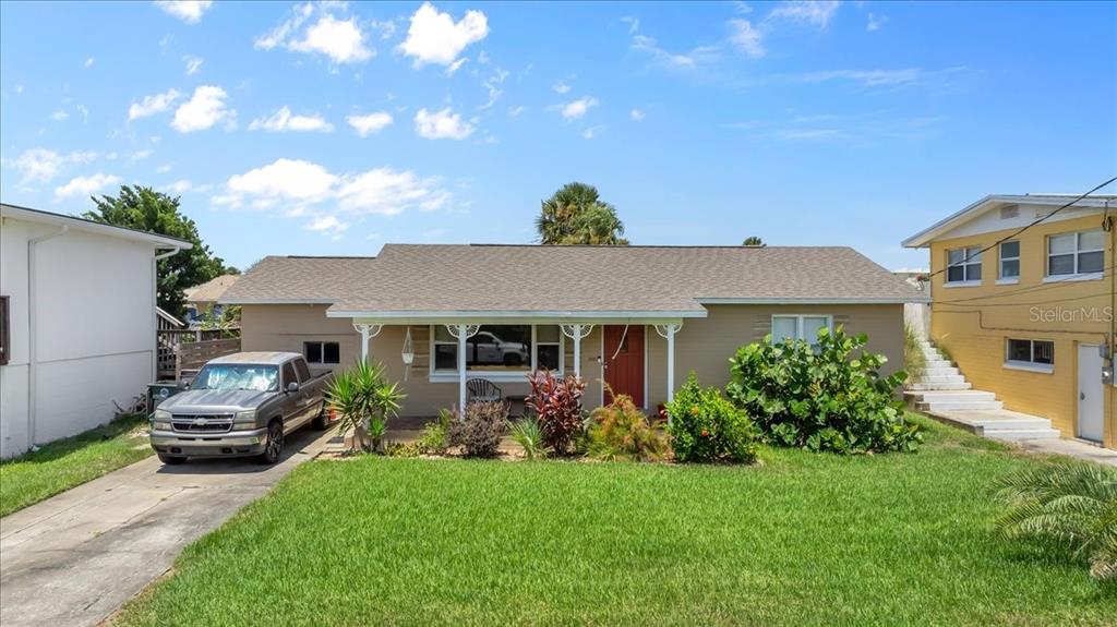 a front view of house with yard and outdoor seating