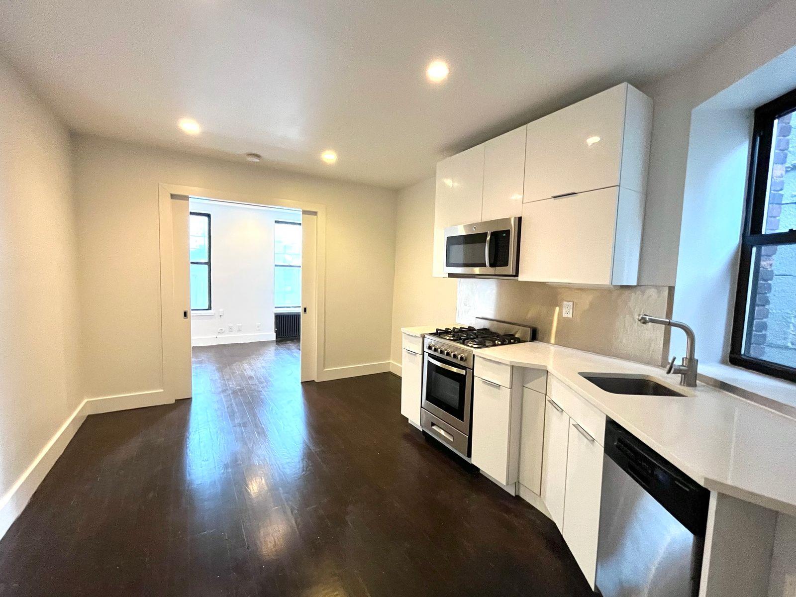 a kitchen with a sink and a stove top oven