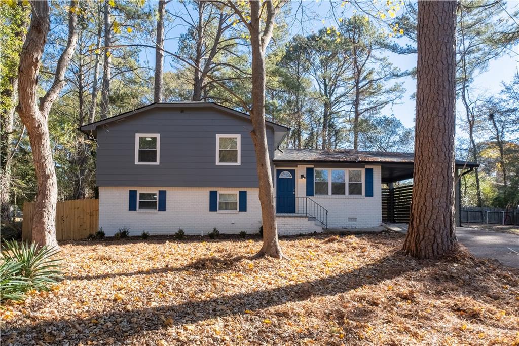 a house that has a tree in front of it