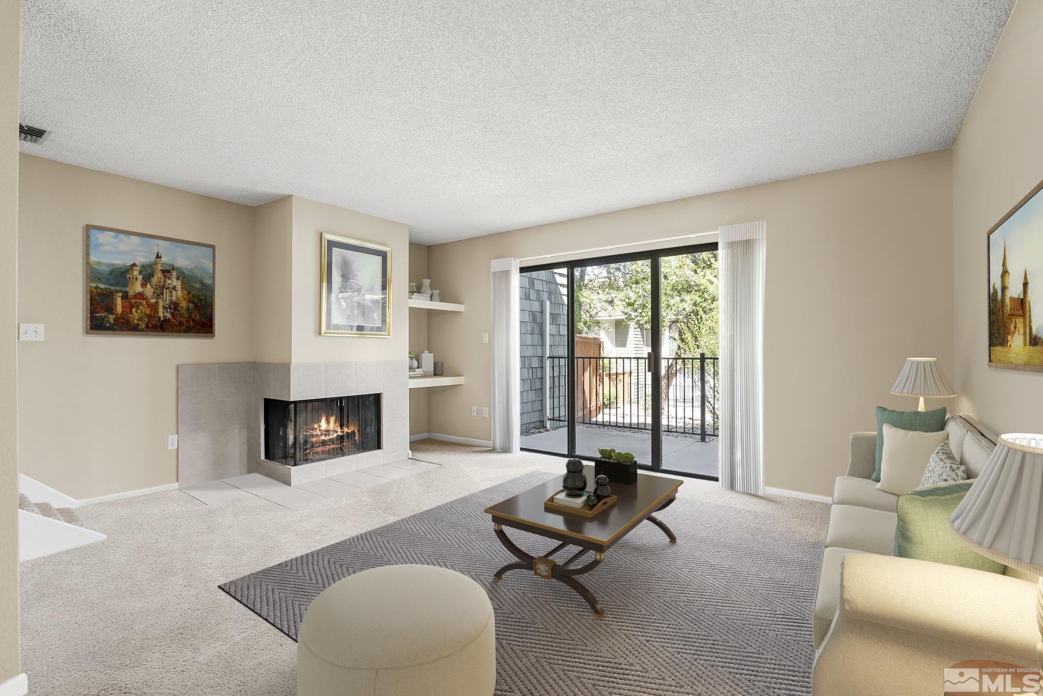 a living room with furniture a fireplace and a floor to ceiling window