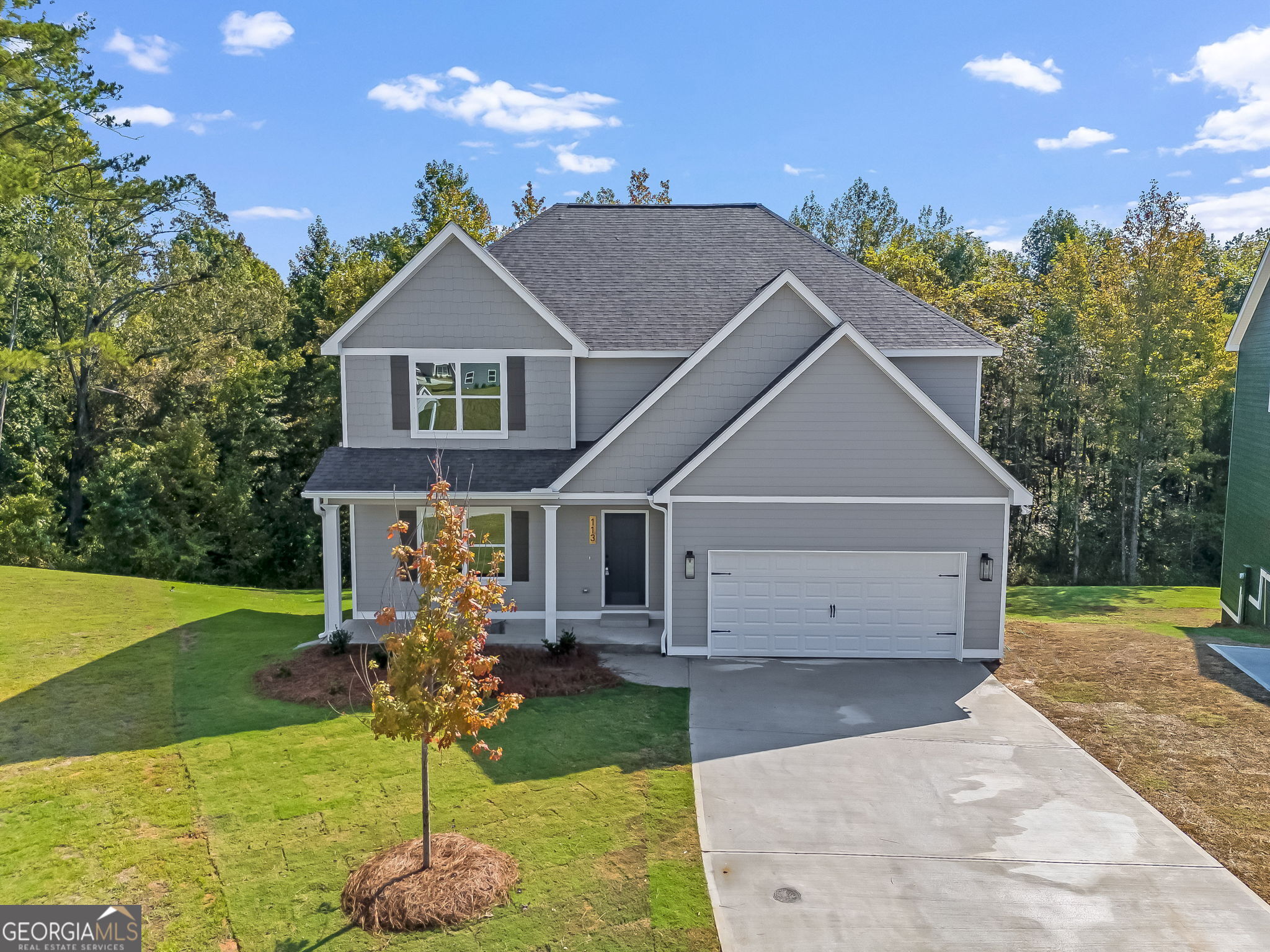 a front view of a house with a yard