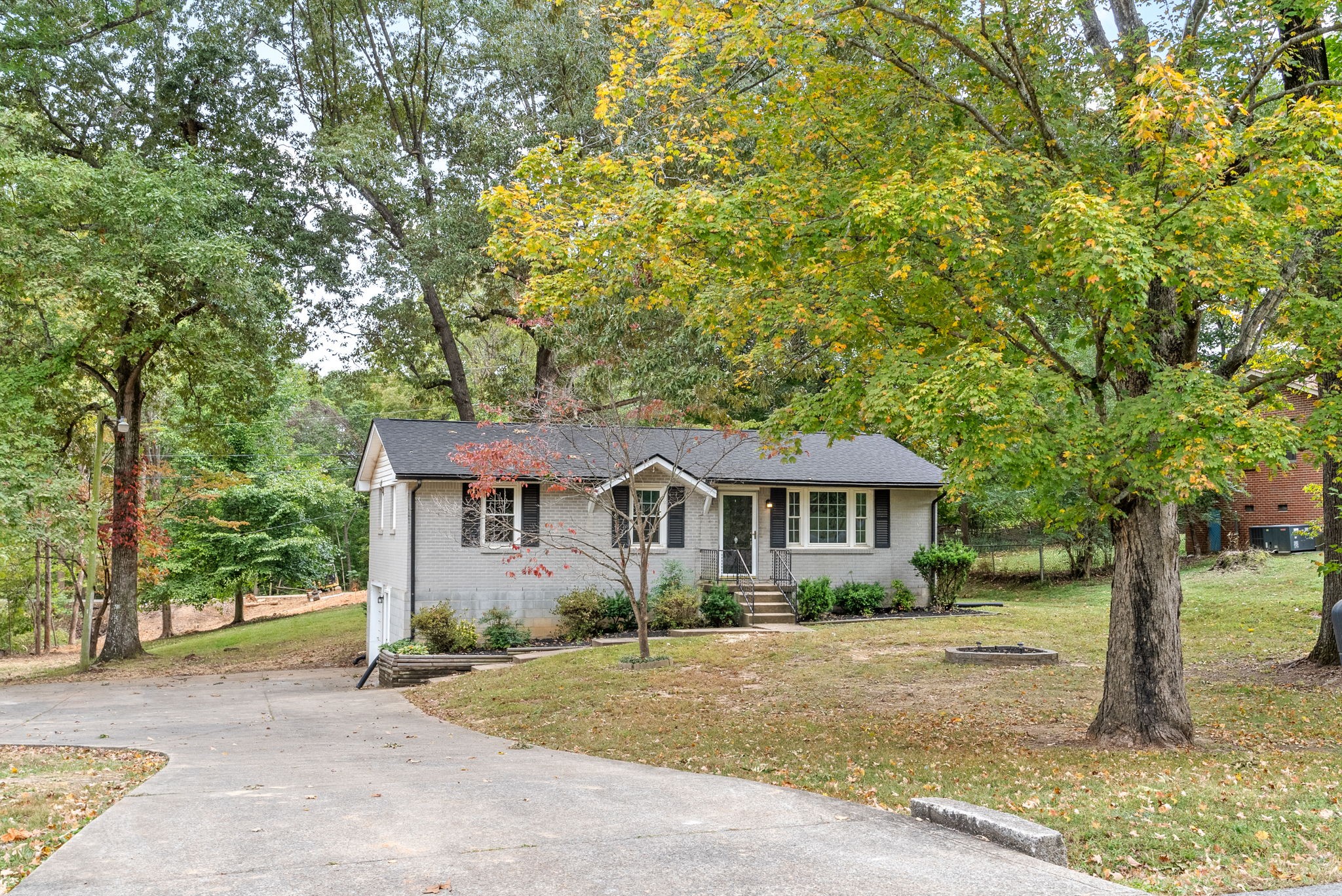 a front view of a house with a garden