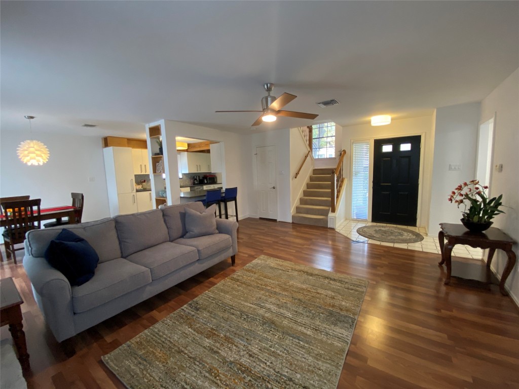 a living room with furniture and wooden floor