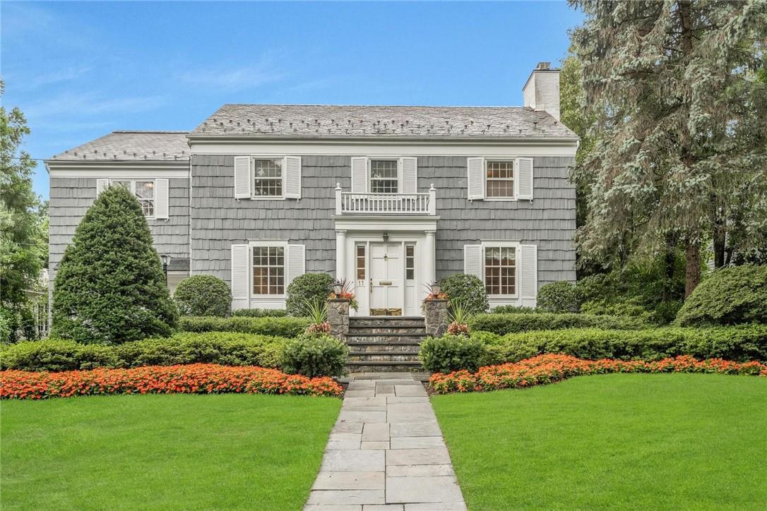 Welcome Home to this stately center hall colonial with private, lush grounds