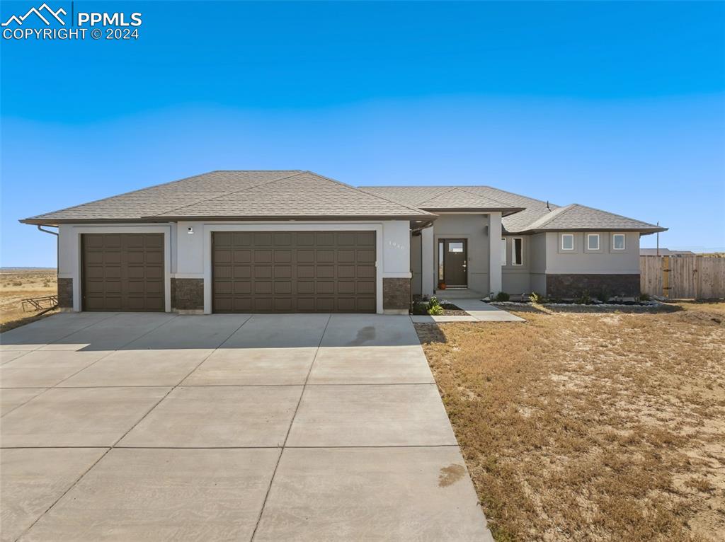 Prairie-style home featuring a garage