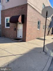 a front view of a house with a road