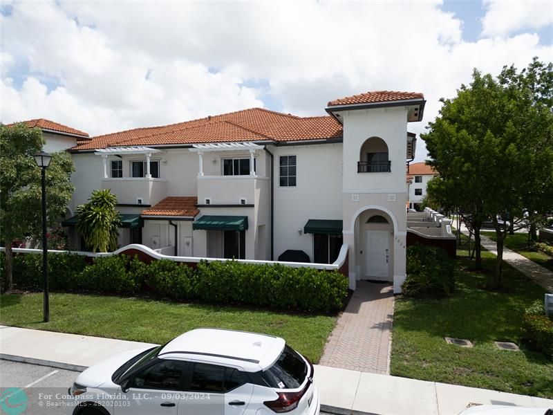 a view of a white house with a yard